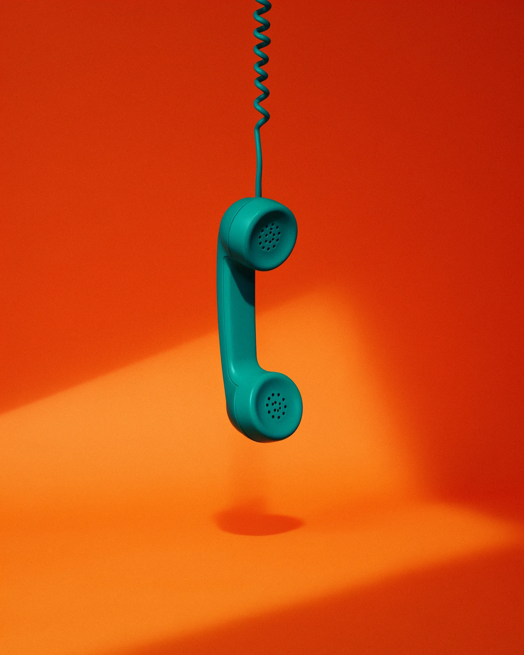Teal telephone handset hangs by its coiled cord against an orange background with a shadow.